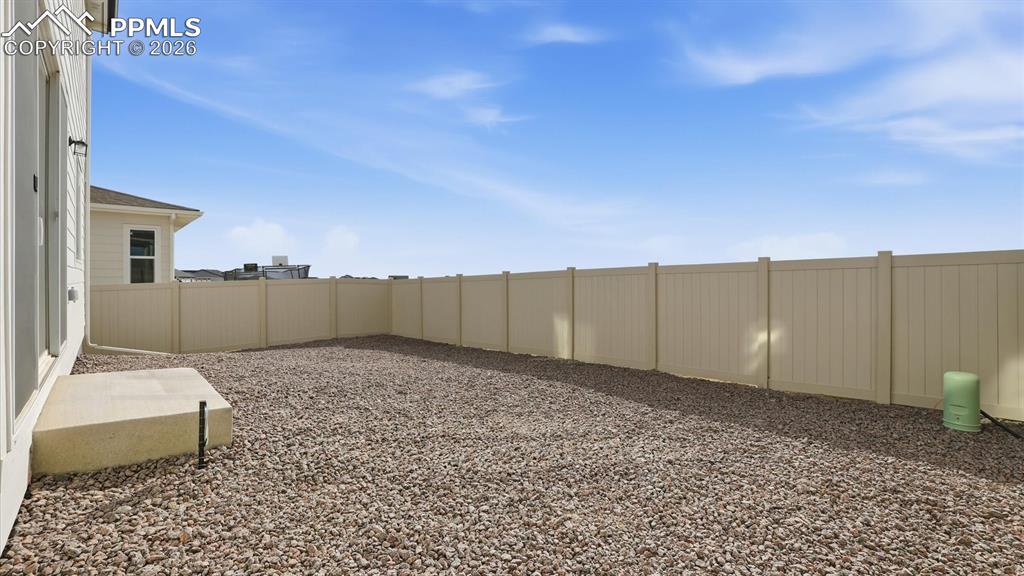 Image 42 of 45: Spacious fenced backyard for outdoor fun and relaxation.