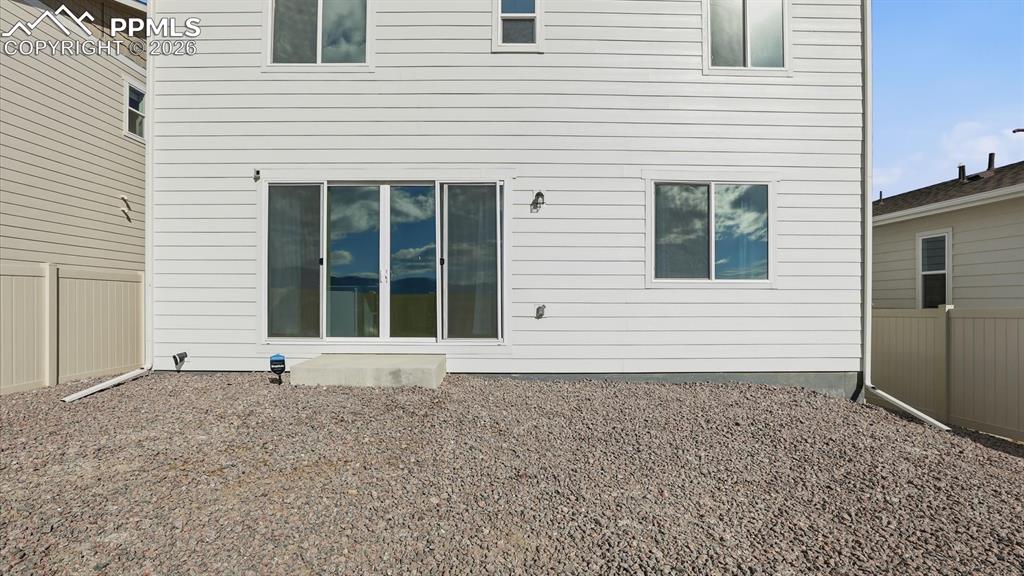 Image 44 of 45: Rear view of backyard and back of structure.