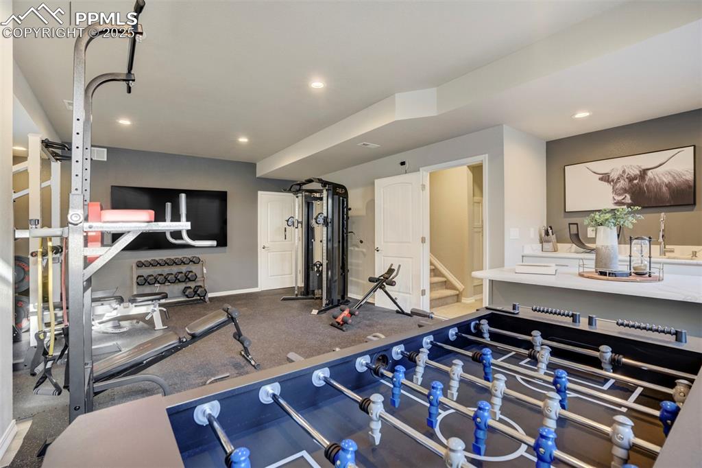 Image 31 of 50: Basement family room is currently being used as a gym. 