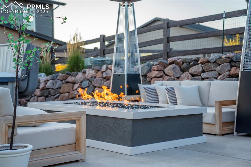 Image 37 of 50: Concrete patio with custom firepit. 