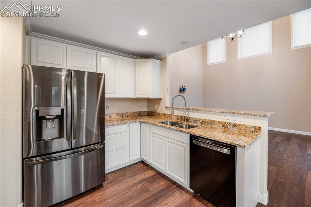 Image 17 of 46: Kitchen with stainless steel fridge with ice dispenser, black dishwasher, d