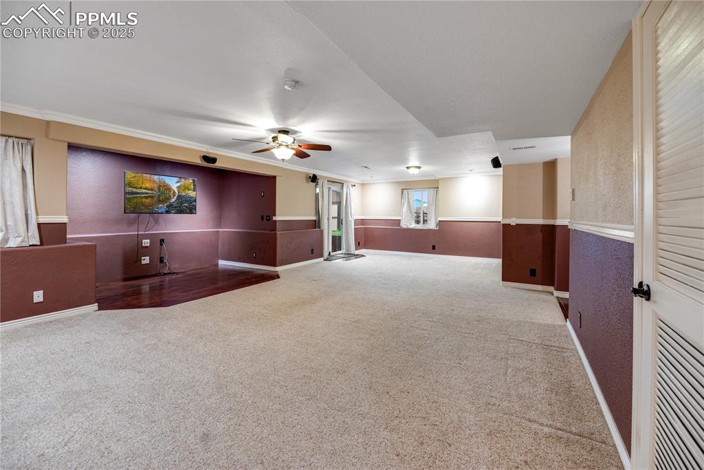 Image 32 of 46: Spare room with ceiling fan, carpet flooring, and a textured wall