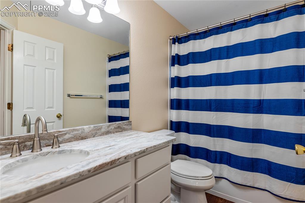 Image 37 of 46: Full bathroom with vanity and wood finished floors