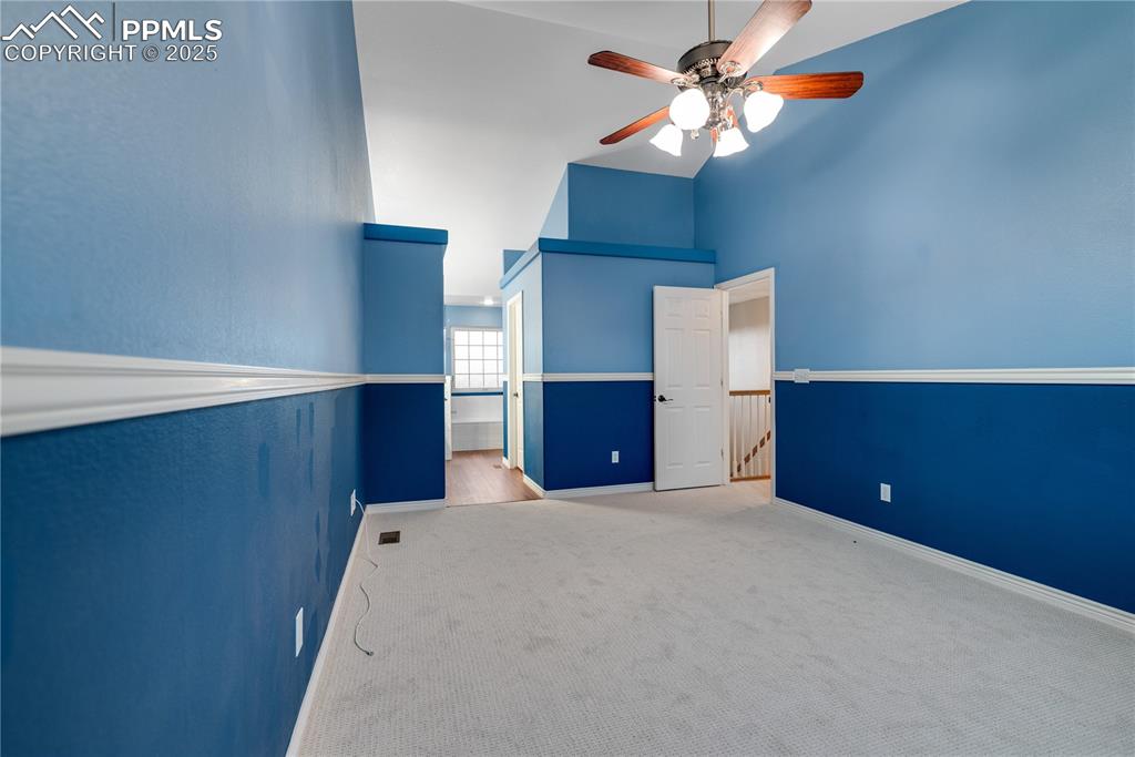 Image 40 of 46: Unfurnished room with high vaulted ceiling, carpet, and ceiling fan