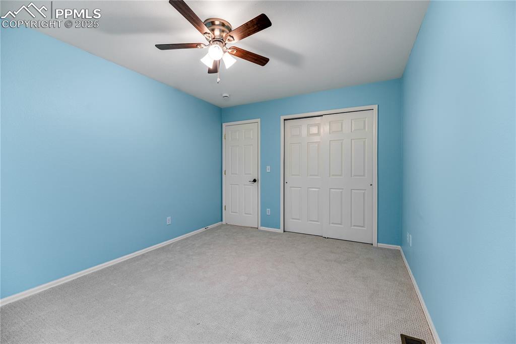Image 45 of 46: Unfurnished bedroom featuring carpet, a ceiling fan, and a closet