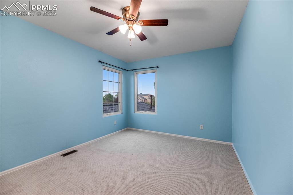 Image 46 of 46: Spare room featuring carpet flooring and a ceiling fan