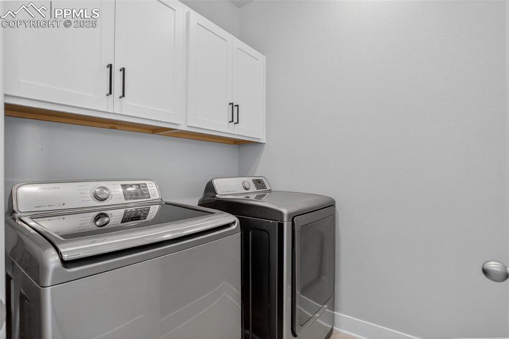 Image 19 of 50: Spacious Laundry Rm with plenty of cupboards. 