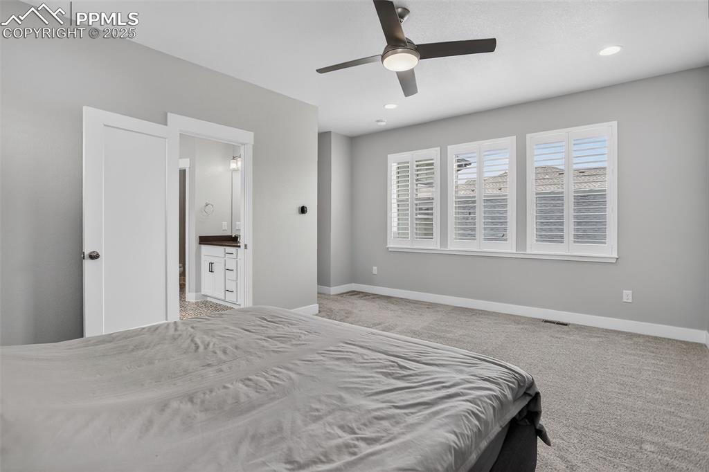 Image 21 of 50: Spacious primary bedroom, plenty of space for King-sized bed and bedroom fu