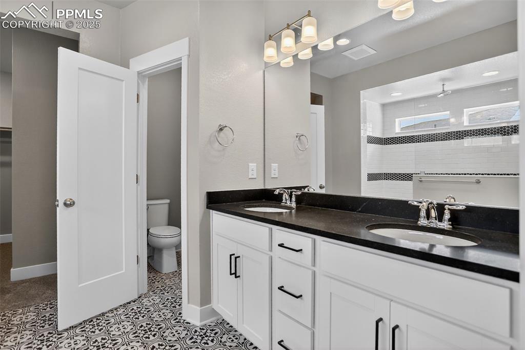Image 25 of 50: Large primary bathroom with coveted separate sinks, beautiful fixtures, upg