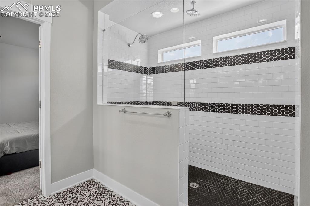 Image 26 of 50: Primary shower with dual shower heads.