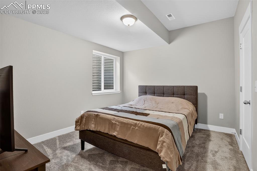 Image 37 of 50: Spacious 13 x 11 basement bedroom with garden level window and walk-in clos