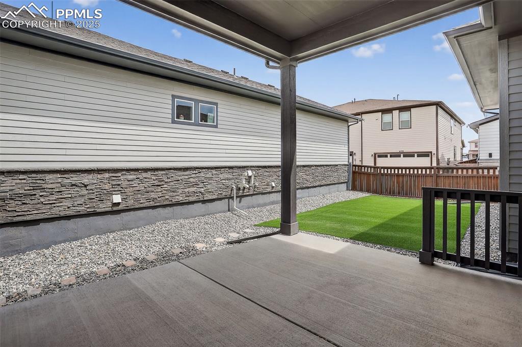 Image 40 of 50: Covered patio with plenty of room for outdoor furniture for entertaining.