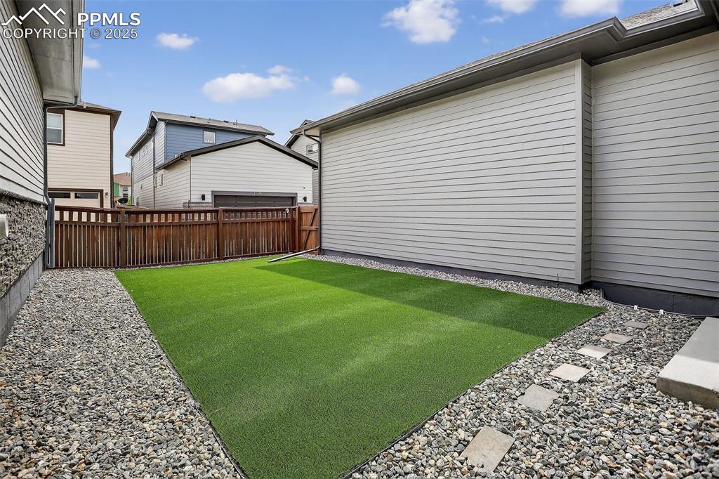 Image 43 of 50: Yard with low maintenance artificial turf.
