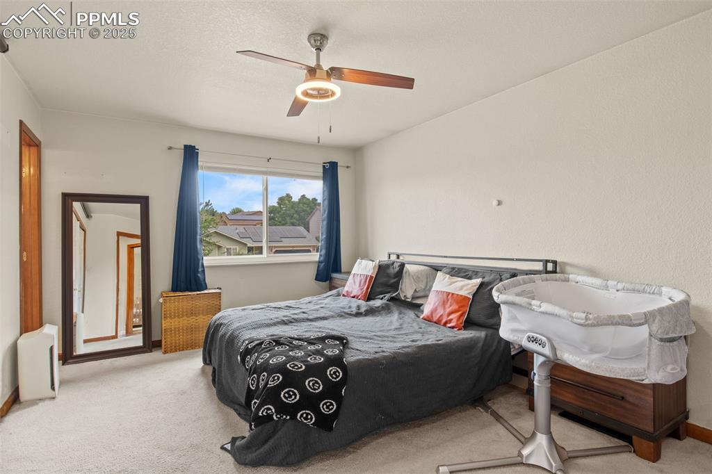Image 19 of 35: Bedroom featuring carpet, a ceiling fan, and a textured ceiling
