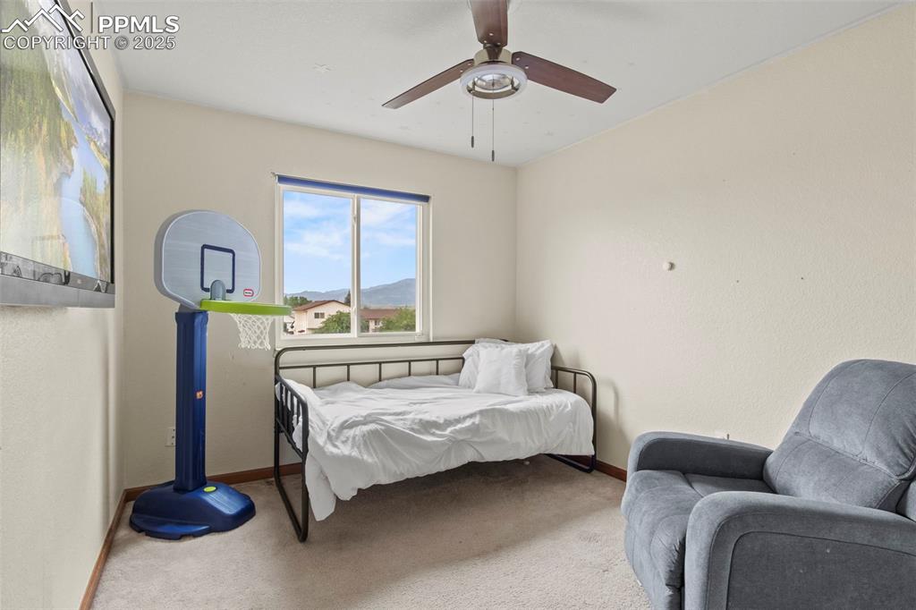 Image 26 of 35: Bedroom with carpet, ceiling fan, and a mountain view