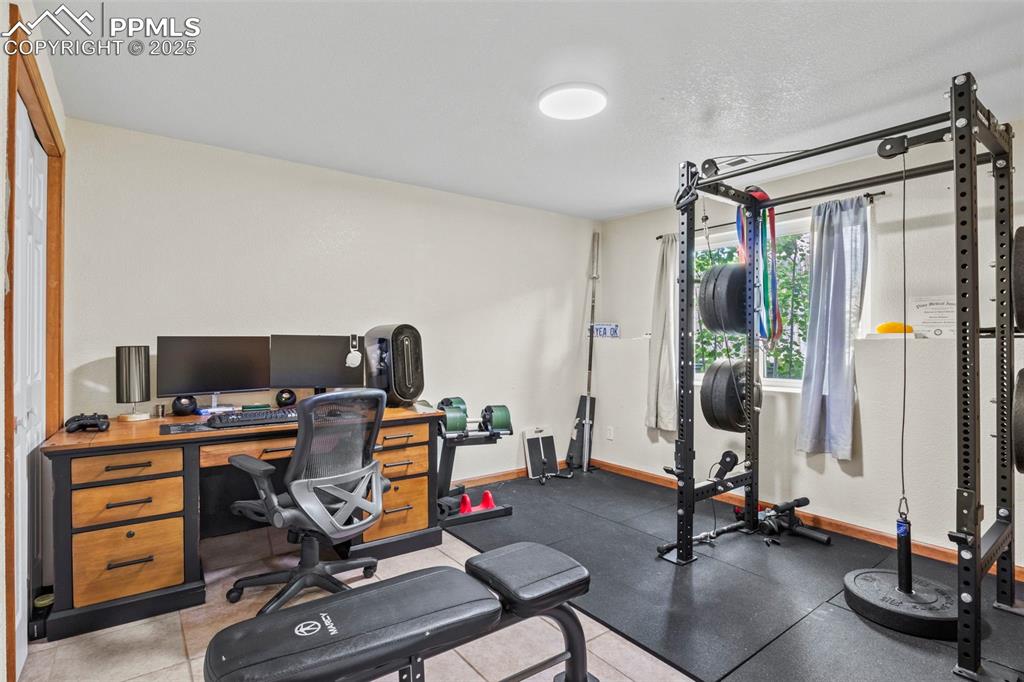 Image 29 of 35: Workout room featuring baseboards