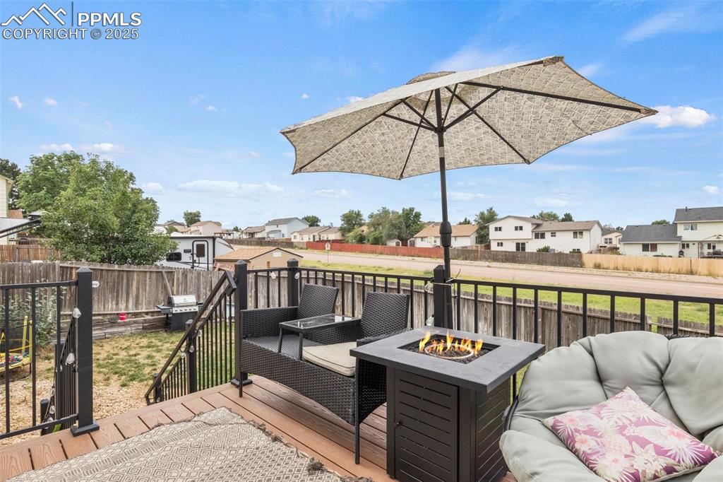 Image 32 of 35: Deck featuring a residential view, a fenced backyard, an outdoor living spa