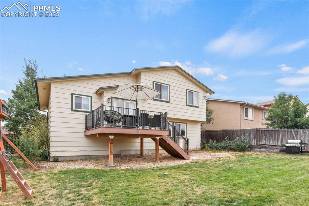 Image 35 of 35: Back of house with stairway and a wooden deck