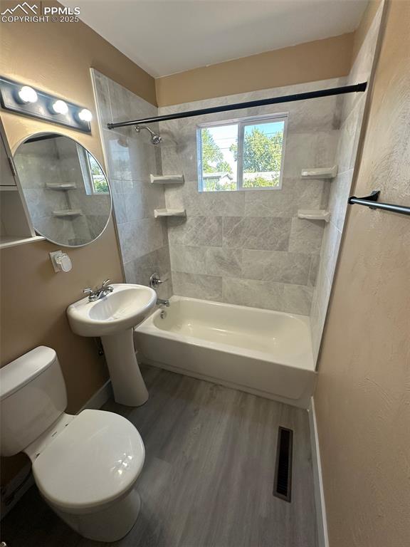 Image 14 of 27: Bathroom featuring tiled shower / bath combo and LVP floors