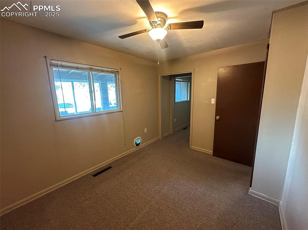 Image 15 of 27: Master bedroom room with ceiling fan and oversized seating area and two clo