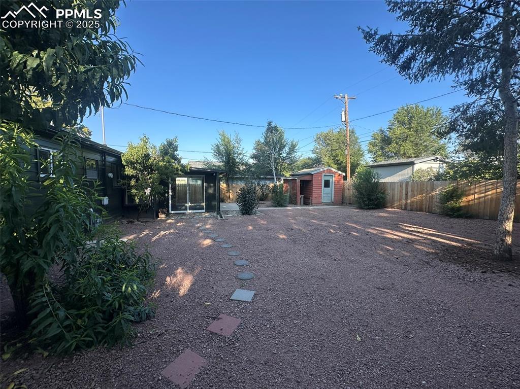 Image 25 of 27: View of yard with peach and aspen trees