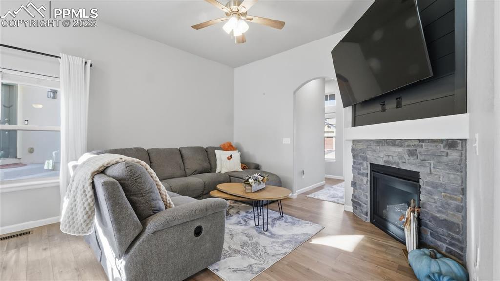 Image 10 of 42: The spacious living room & dining area, anchored by a cozy fireplace with s