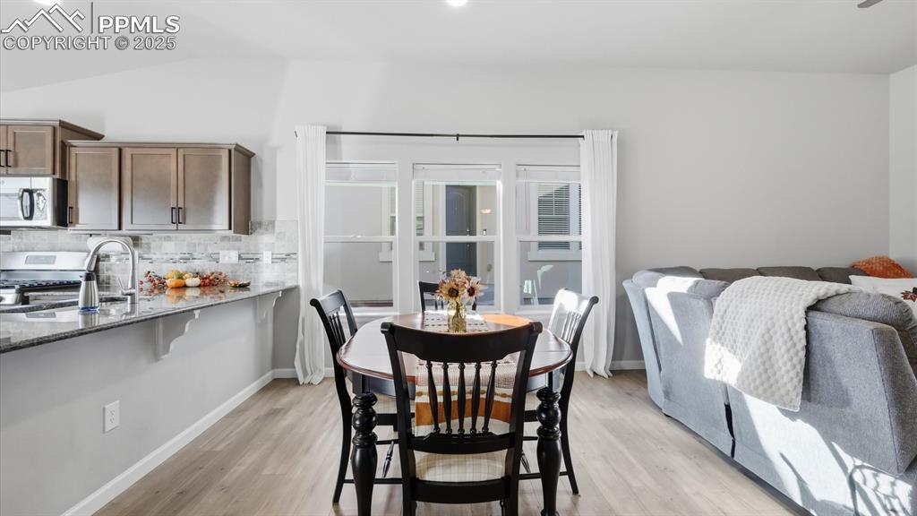 Image 12 of 42: The Dining Area is conveniently located between the Kitchen and the Living 