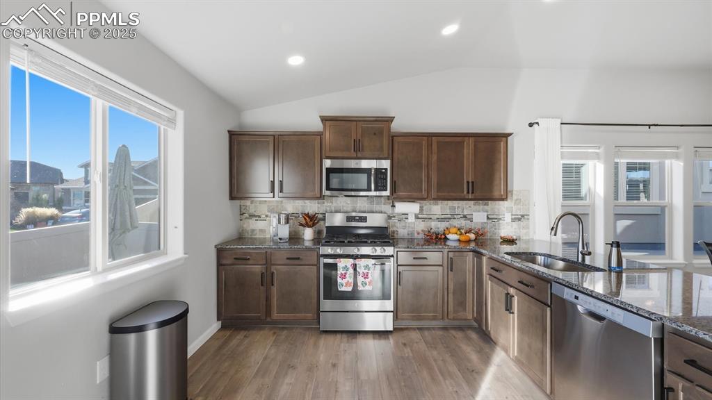 Image 17 of 42: Stainless steel appliances include a gas range oven, microwave oven, dishwa