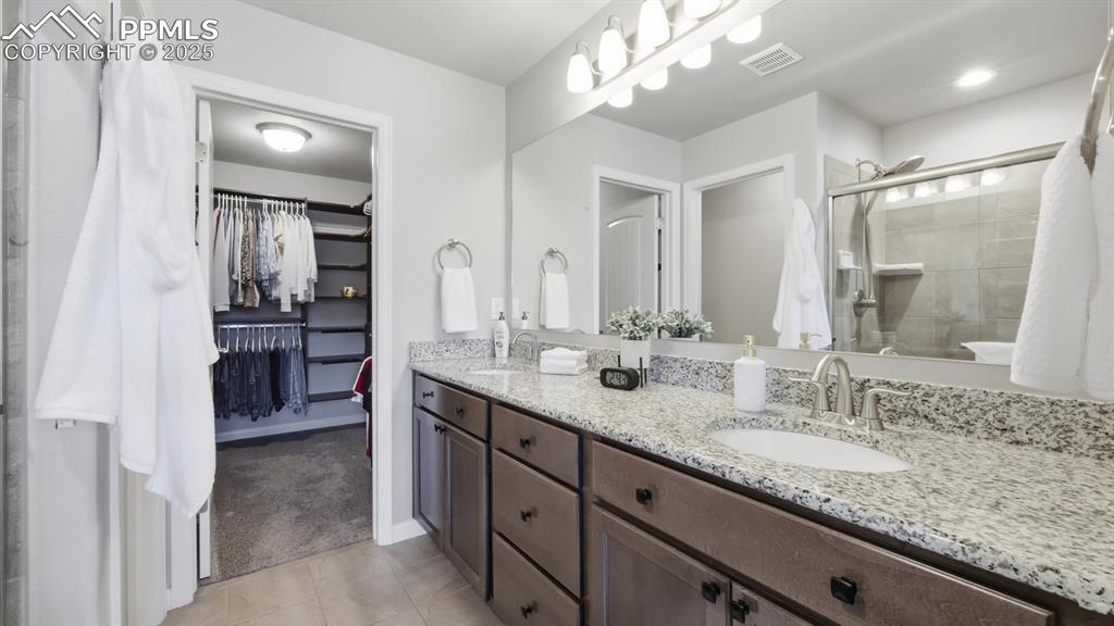 Image 22 of 42: The Primary Bathroom offers a double sink vanity, oversized shower, & custo
