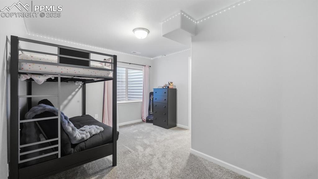 Image 28 of 42: Basement Bedroom #2 with neutral carpet.