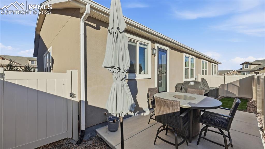 Image 38 of 42: Backyard patio with gate to the front yard.