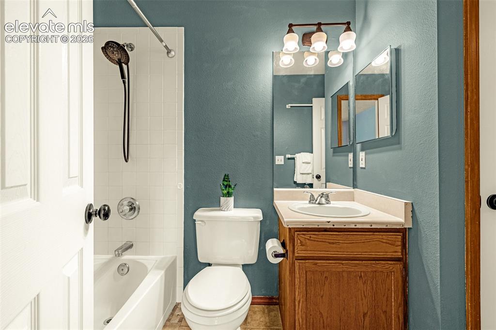 Image 5 of 15: Bathroom featuring a white bathtub and shower with subway tile surround, a 