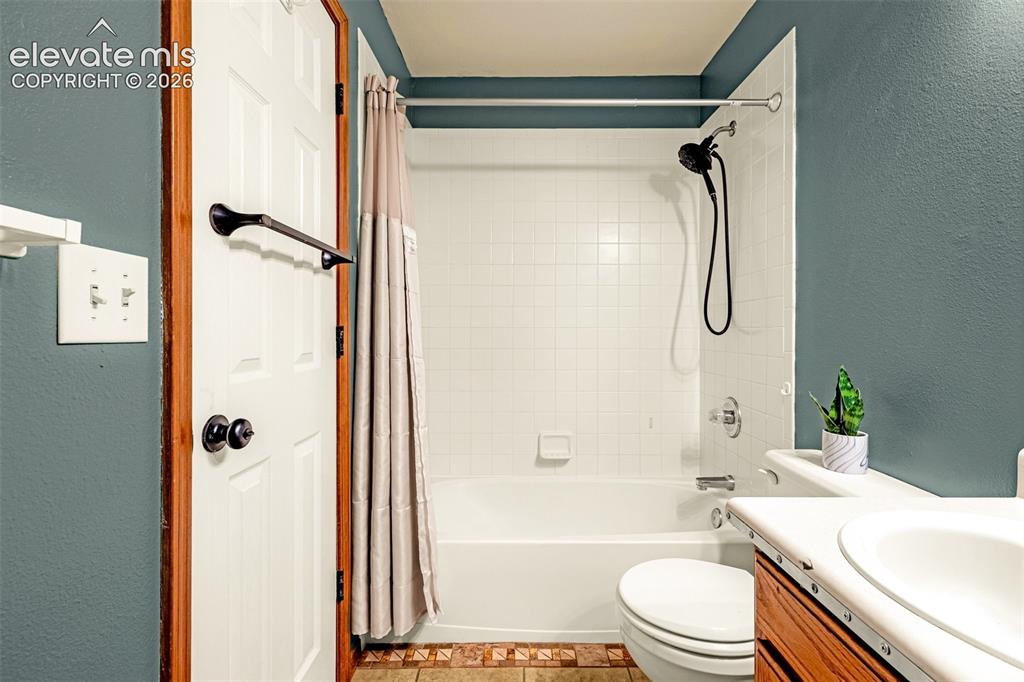 Image 6 of 15: Bathroom featuring a white bathtub and shower combination with a black show