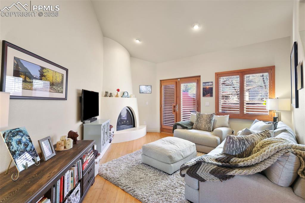 Image 2 of 19: Living room featuring light wood-type flooring and a large fireplace