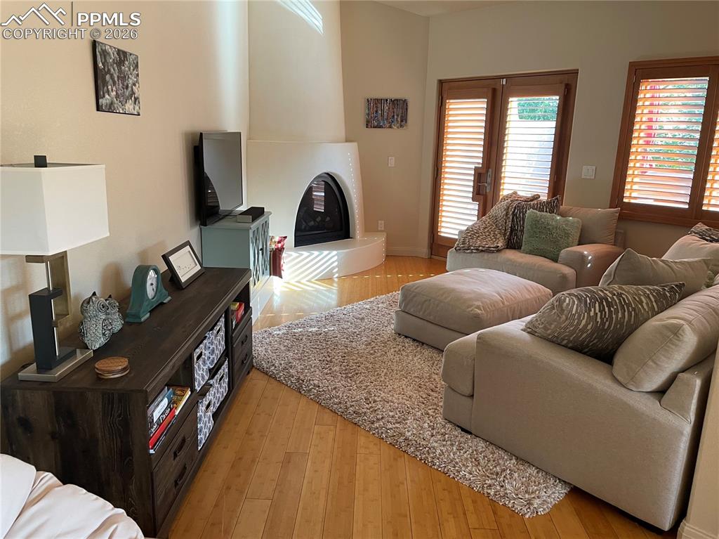 Image 28 of 28: Living room featuring light wood finished floors and a gas fireplace