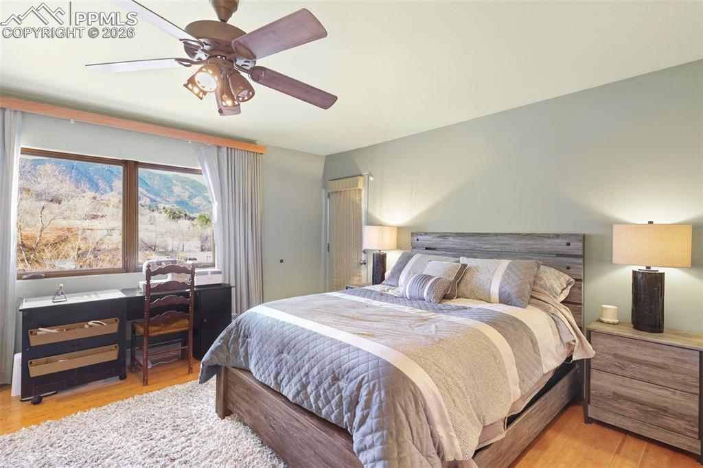Image 9 of 19: Bedroom with light wood-type flooring and a ceiling fan