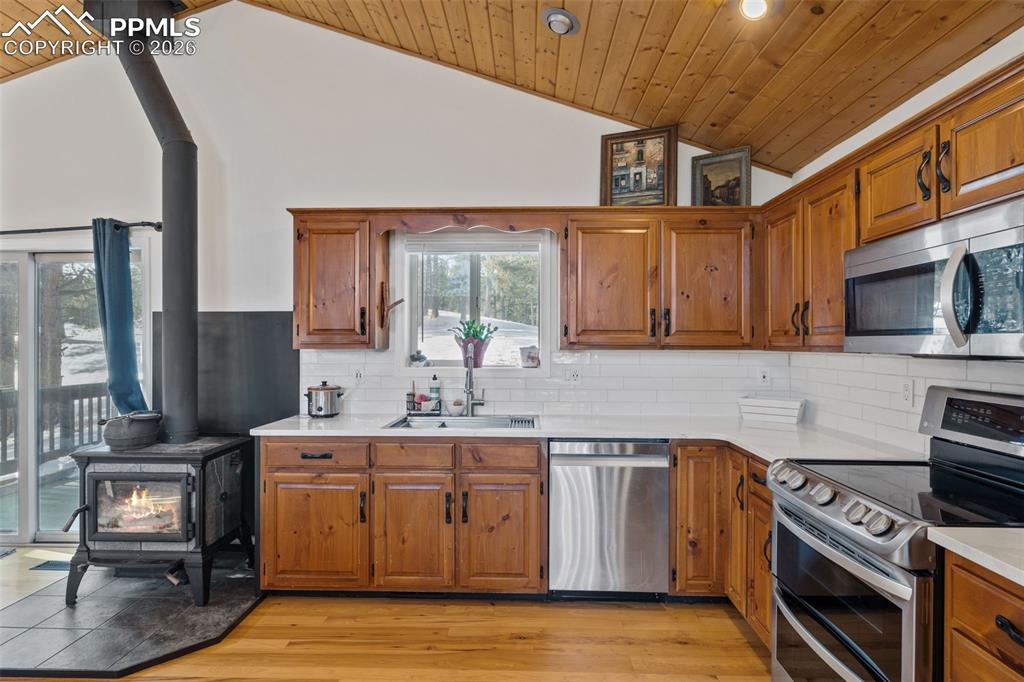 Image 12 of 47: Kitchen with wood stove