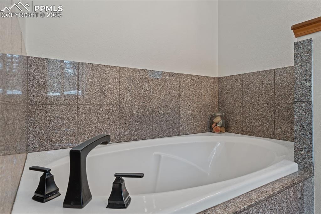 Image 19 of 47: Primary bath soaking tub