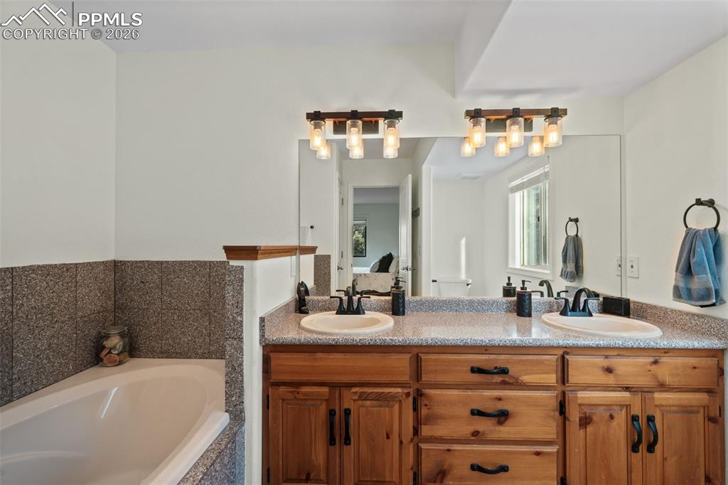 Image 5 of 47: Primary bath with soaking tub and double vanity