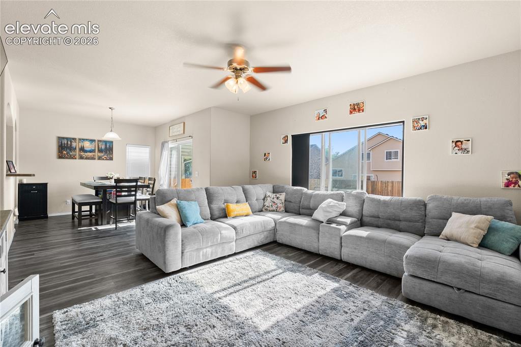 Image 14 of 41: Open-concept living area with wood-finish flooring, recessed lighting, and 