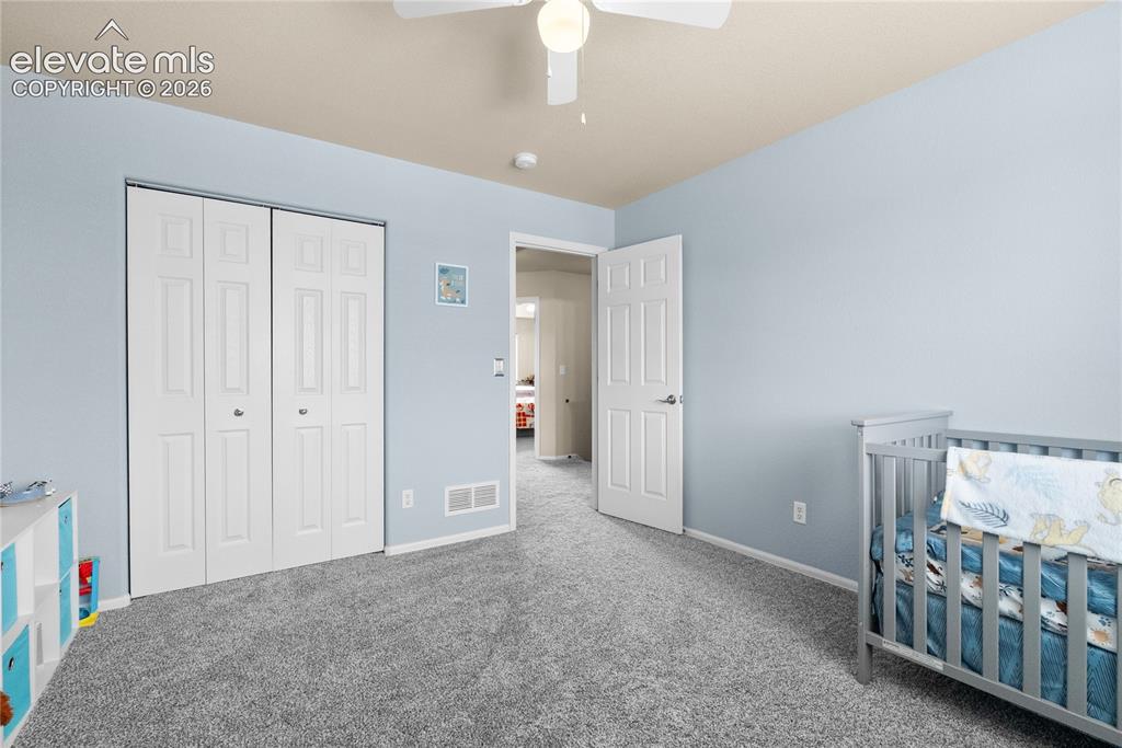 Image 25 of 41: Wall-to-wall carpeting and a ceiling fan with integrated lighting