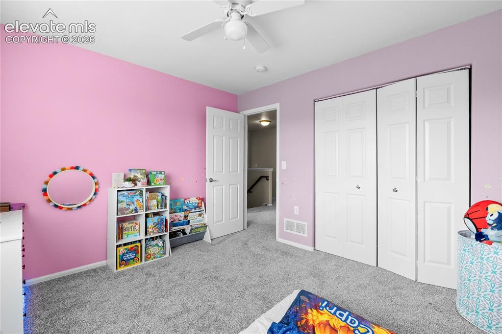 Image 27 of 41: Spacious room with a ceiling fan, plush gray carpeting, and ample closet sp