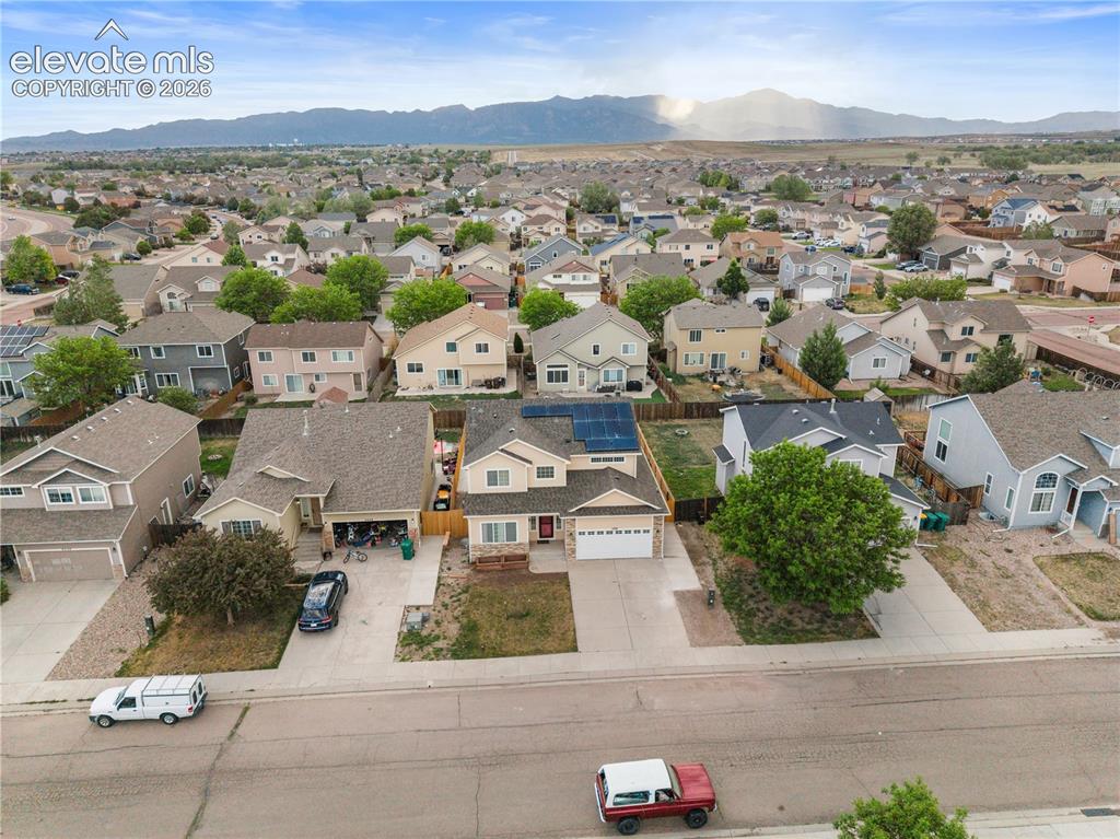 Image 34 of 41: Aerial view showcasing a beige two-story residence with an attached two-car