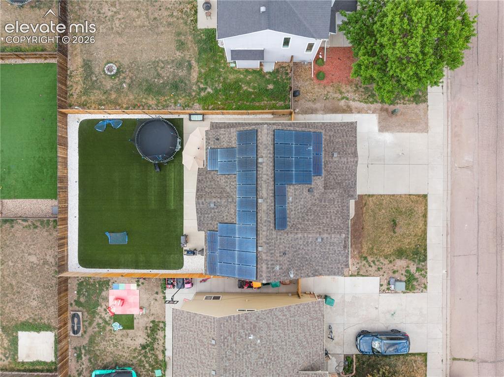Image 36 of 41: Expansive backyard featuring artificial turf, concrete patio, and full peri