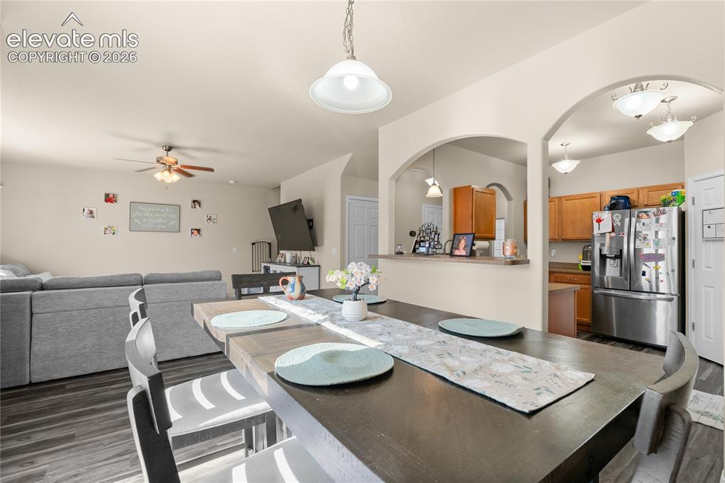Image 5 of 41: Open-concept living space featuring wood-finish flooring, recessed lighting