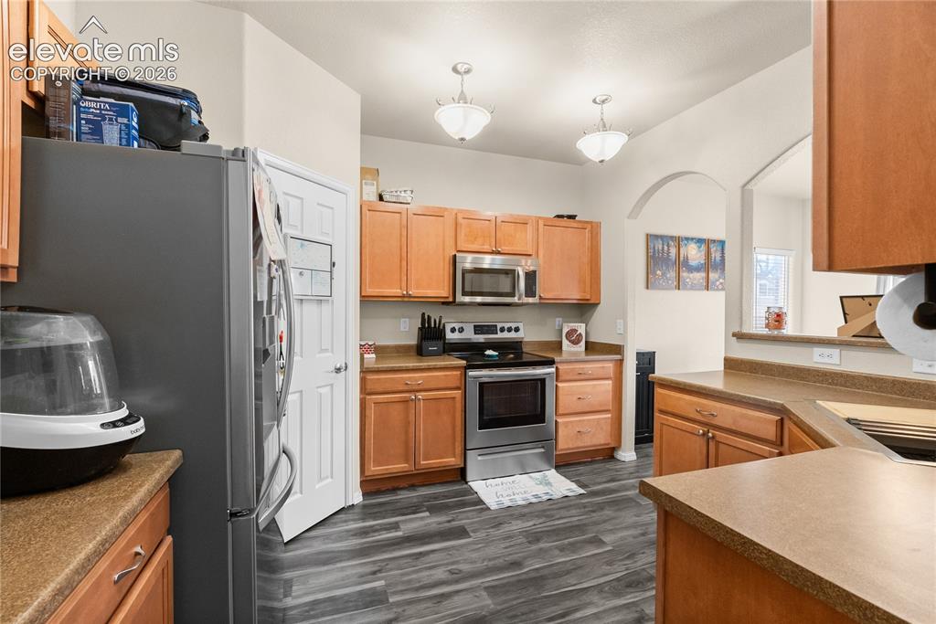 Image 6 of 41: Kitchen featuring wood-finish flooring and light wood cabinetry