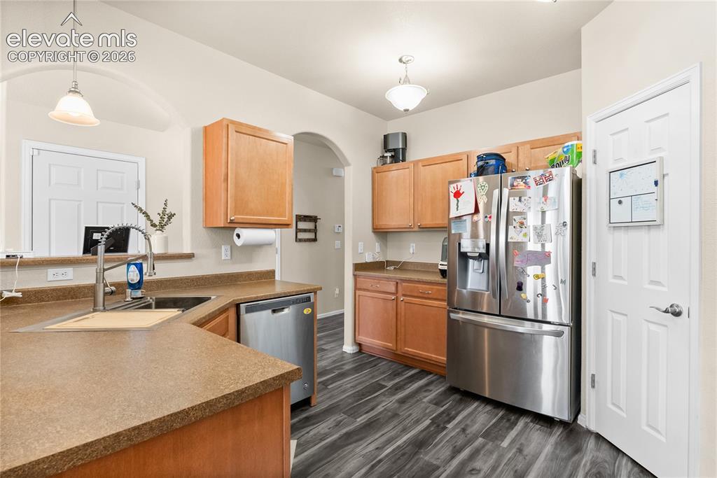 Image 8 of 41: Kitchen featuring wood-finish flooring, light wood cabinetry, and a stainle