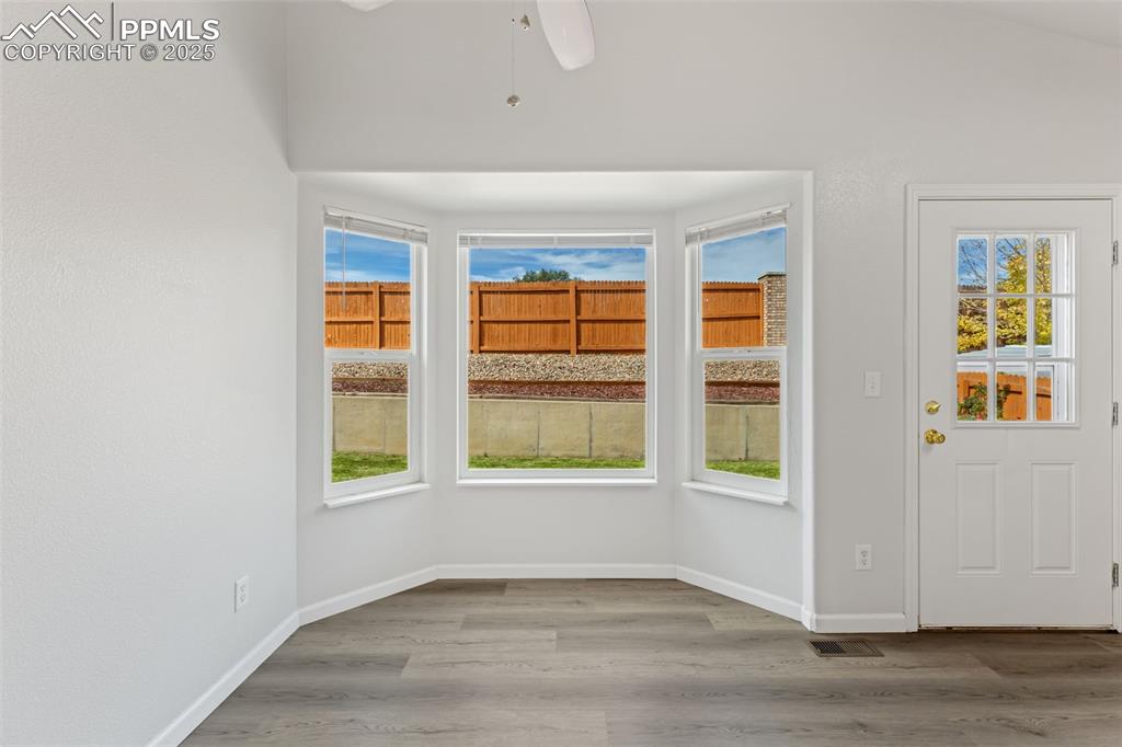 Image 11 of 34: Dining area with newer laminate flooring