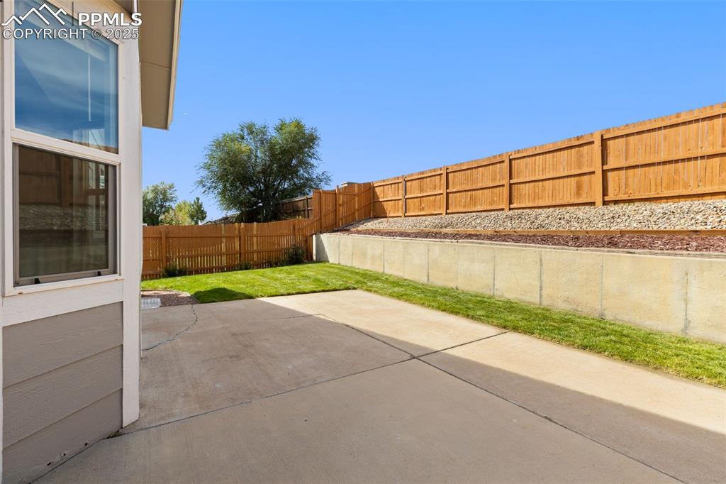 Image 30 of 34: Large concrete patio easy access from kitchen
