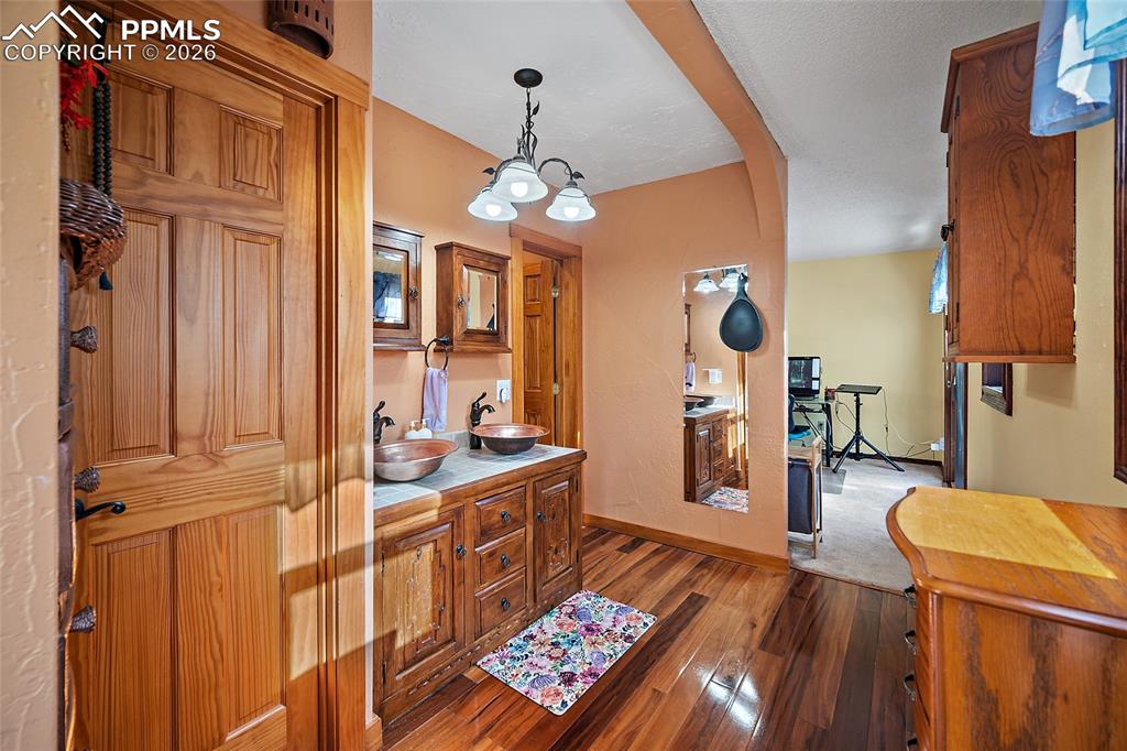 Image 14 of 32: Master Bathroom leading to office/extra space in background.
